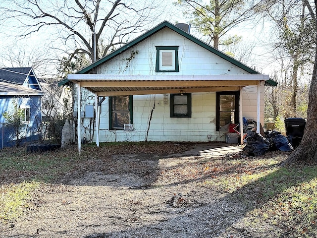 back of house featuring a porch