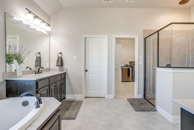 bathroom with tile patterned floors, vanity, lofted ceiling, and shower with separate bathtub