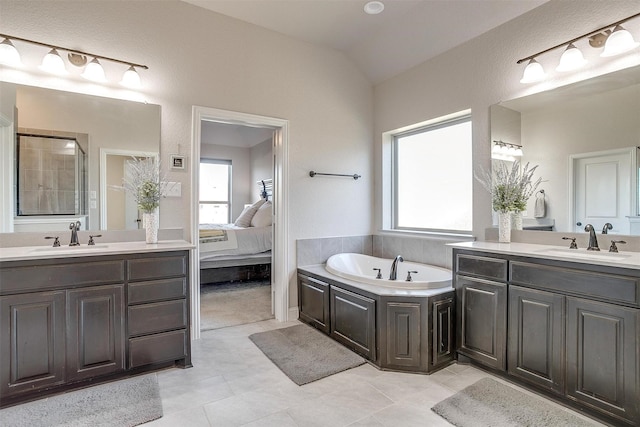 bathroom with tile patterned floors, vanity, and lofted ceiling