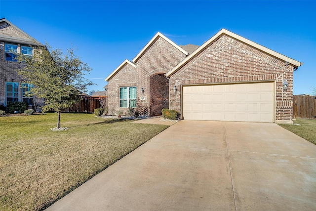 view of front of property featuring a garage and a front lawn