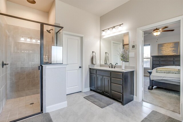 bathroom featuring tile patterned floors, ceiling fan, vanity, and walk in shower