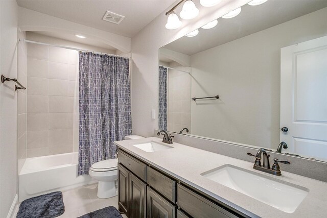 full bathroom with tile patterned floors, vanity, toilet, and shower / tub combo