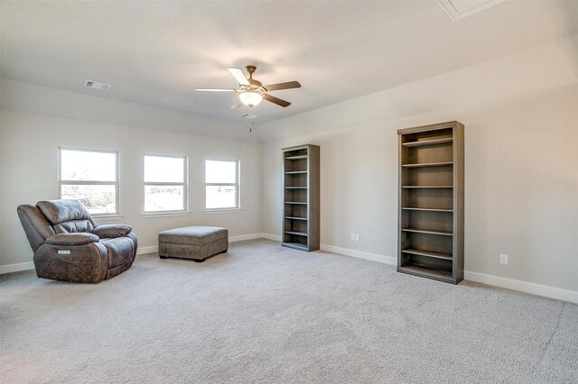 sitting room with light colored carpet and ceiling fan