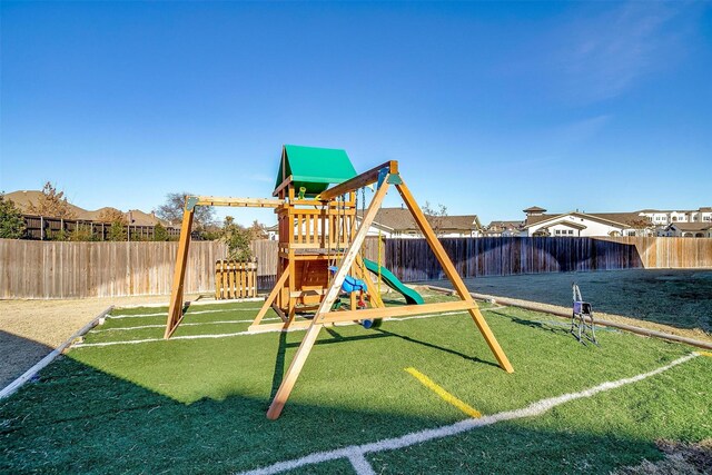 view of jungle gym featuring a lawn