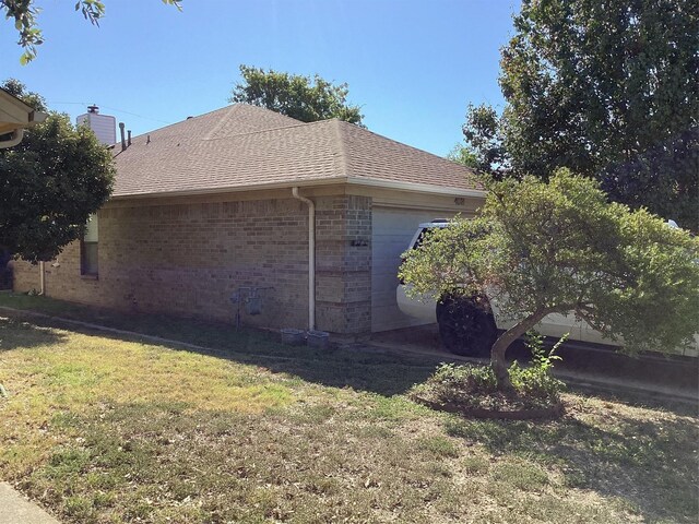 view of home's exterior featuring a lawn and a garage