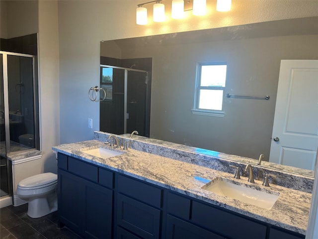 full bathroom featuring a shower stall, toilet, and a sink