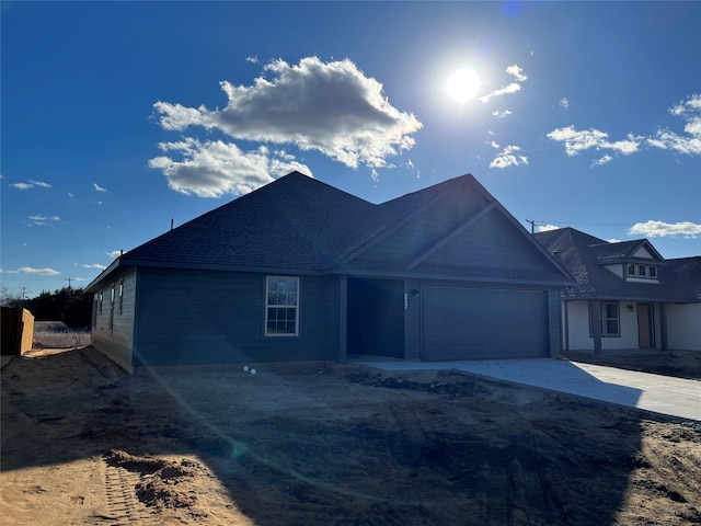 view of front of house featuring concrete driveway and an attached garage