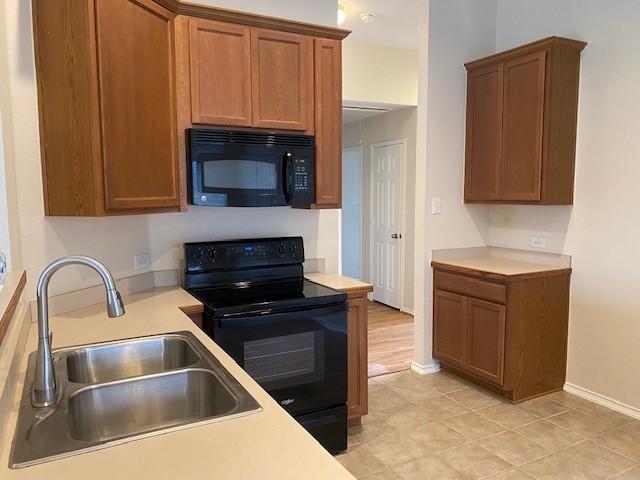 kitchen featuring sink and black appliances