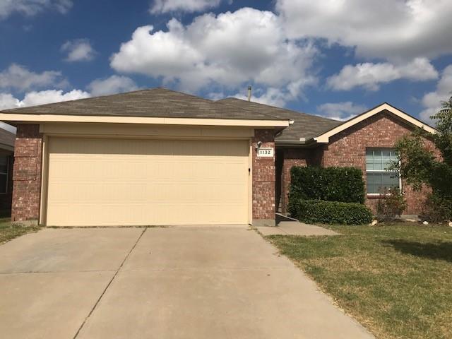 ranch-style house with a garage and a front yard