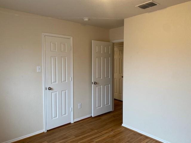 unfurnished bedroom featuring dark wood-type flooring