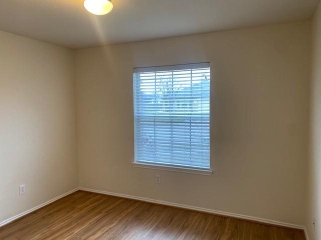 unfurnished room with wood-type flooring