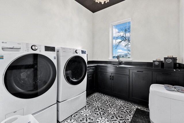 laundry room featuring washer and dryer, cabinets, light tile patterned floors, and sink