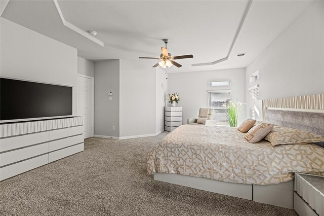 living room with ceiling fan, a fireplace, a high ceiling, and light hardwood / wood-style flooring