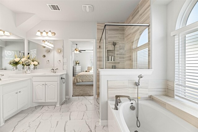 full bathroom featuring marble finish floor, a garden tub, a shower stall, vanity, and baseboards