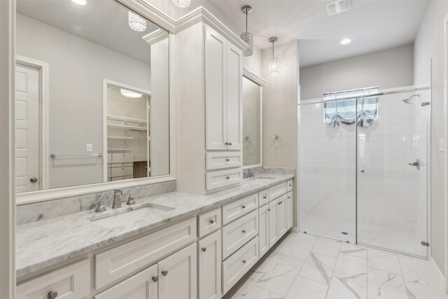 bathroom featuring vanity and a shower with shower door