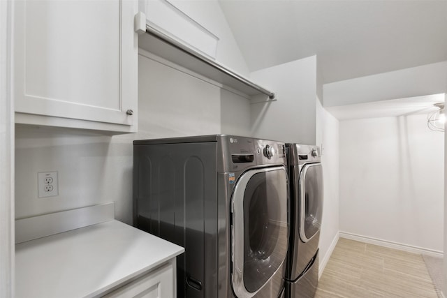 laundry room with cabinets and washer and clothes dryer