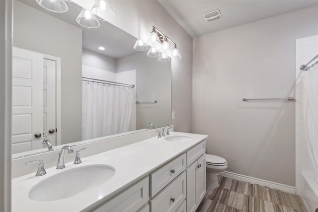 full bathroom with shower / bathtub combination with curtain, vanity, and toilet