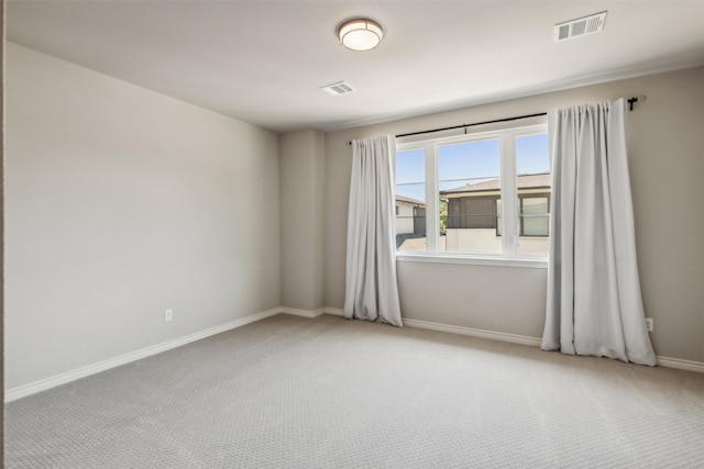 unfurnished room featuring light colored carpet