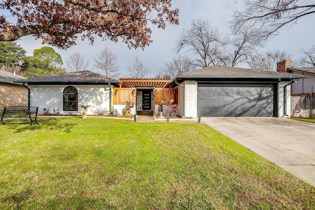 single story home featuring a garage and a front lawn