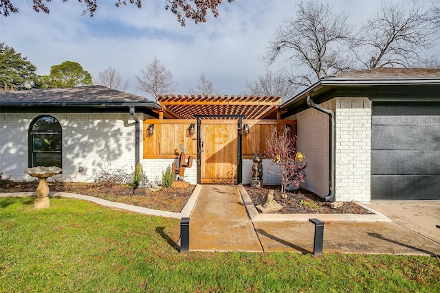 exterior space with a pergola, a garage, and a front lawn