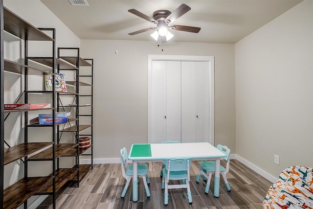 recreation room with ceiling fan and wood-type flooring