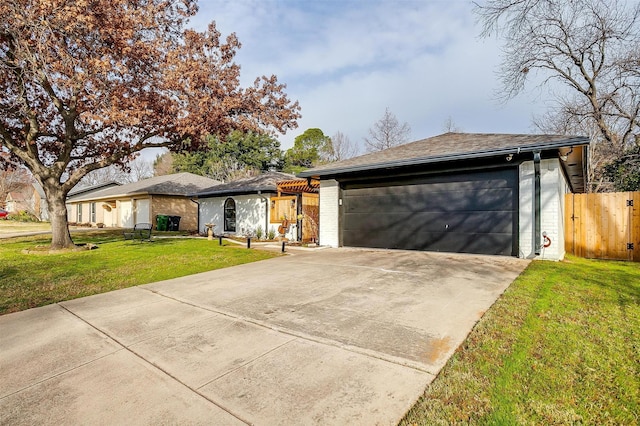 single story home with a garage and a front lawn