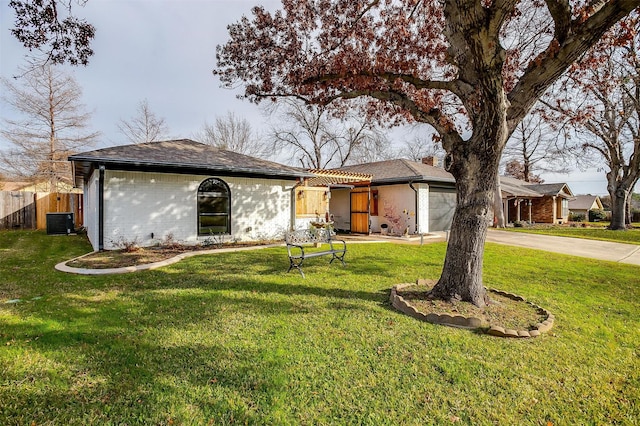 single story home featuring a front lawn and central AC unit