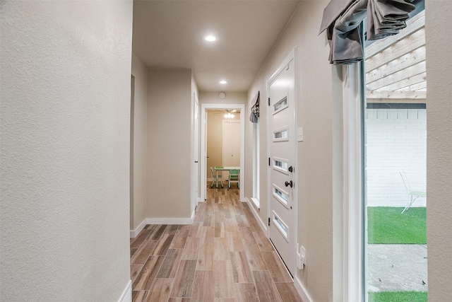 corridor with light wood-type flooring