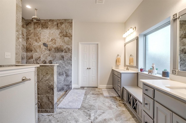 bathroom with vanity and a tile shower