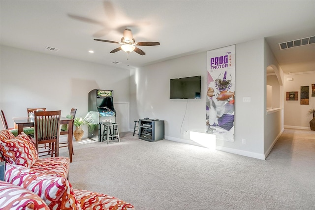 carpeted living room with ceiling fan