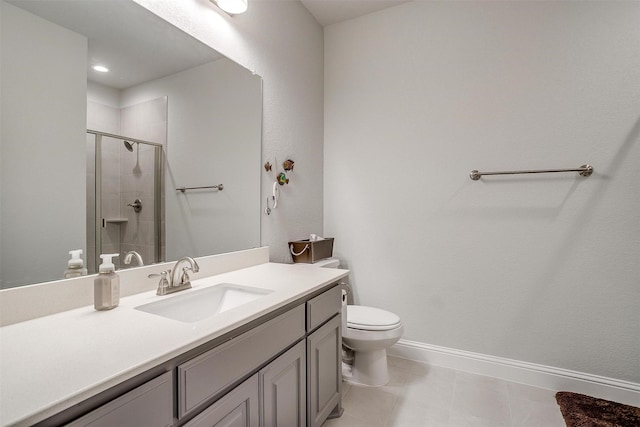 bathroom with toilet, vanity, and a shower with shower door