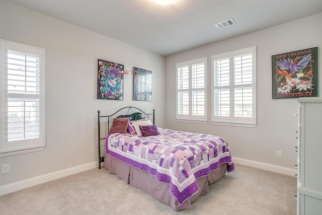 bedroom featuring light carpet