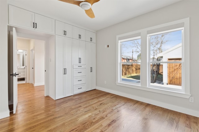 unfurnished bedroom with ceiling fan, light hardwood / wood-style floors, and a closet