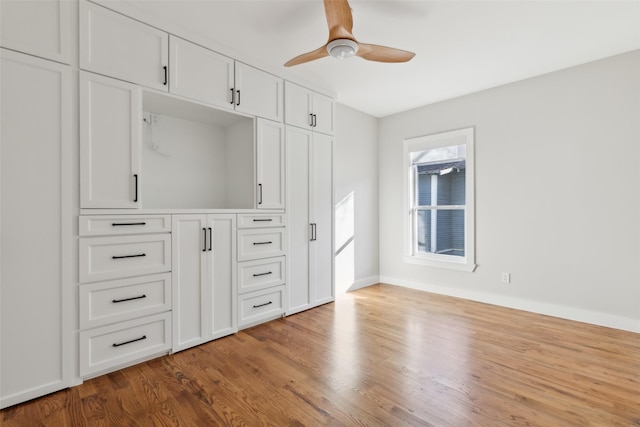 unfurnished bedroom with ceiling fan and wood-type flooring