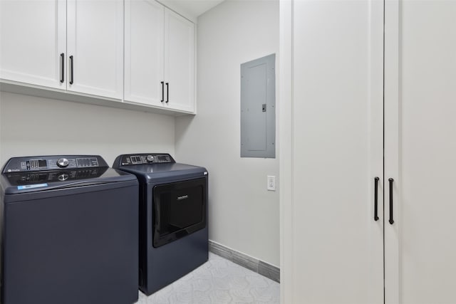 laundry area with cabinets, electric panel, and washer and clothes dryer