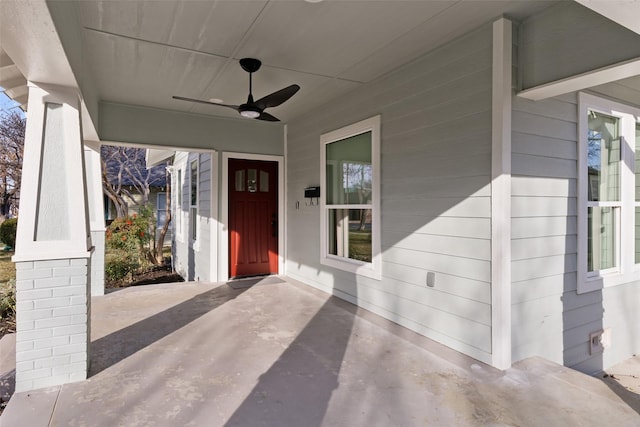 view of exterior entry featuring ceiling fan