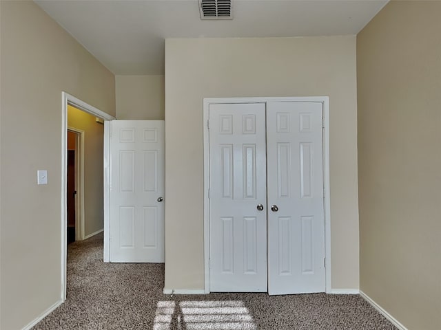 unfurnished bedroom with carpet and a closet