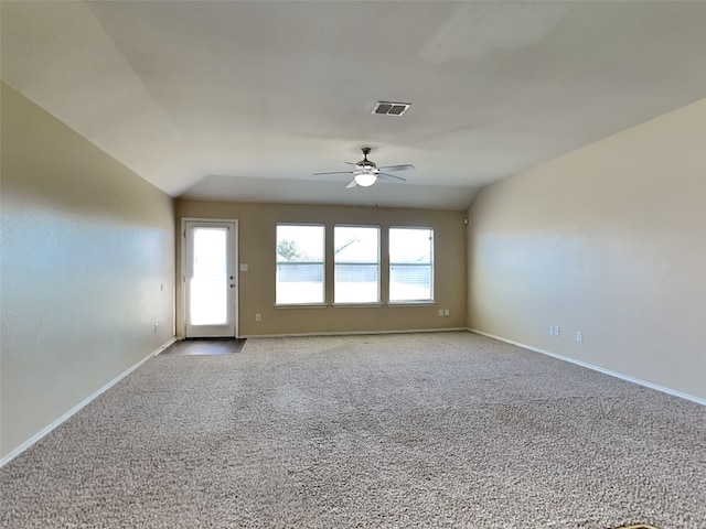 unfurnished room featuring light colored carpet, vaulted ceiling, and ceiling fan