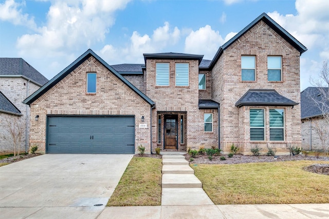 view of front of home with a front yard and a garage