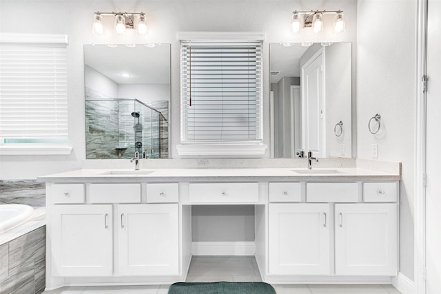 bathroom with separate shower and tub, tile patterned flooring, and vanity