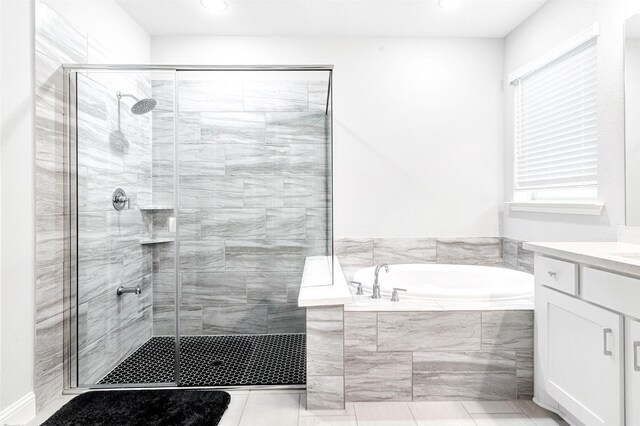 bathroom with tile patterned flooring, vanity, and independent shower and bath