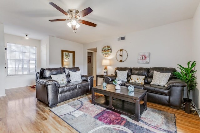 living room featuring light hardwood / wood-style floors and ceiling fan