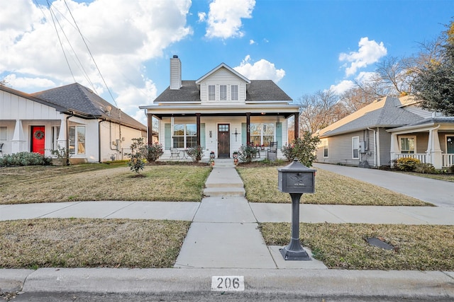 bungalow-style house featuring a porch and a front lawn