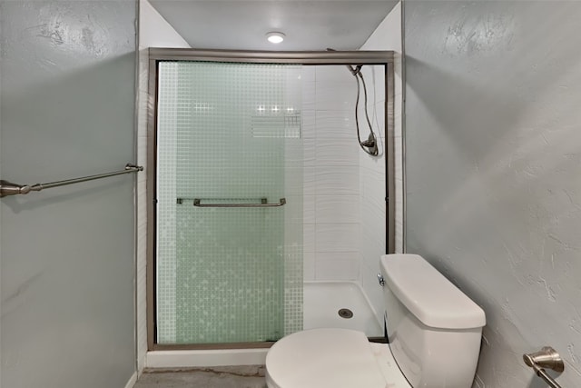 bathroom featuring toilet and walk in shower