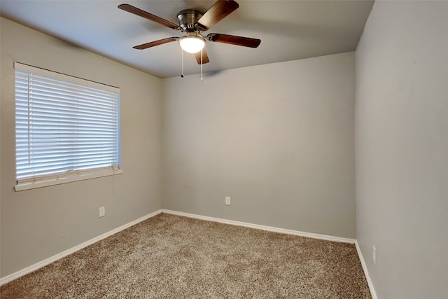 spare room with ceiling fan and carpet