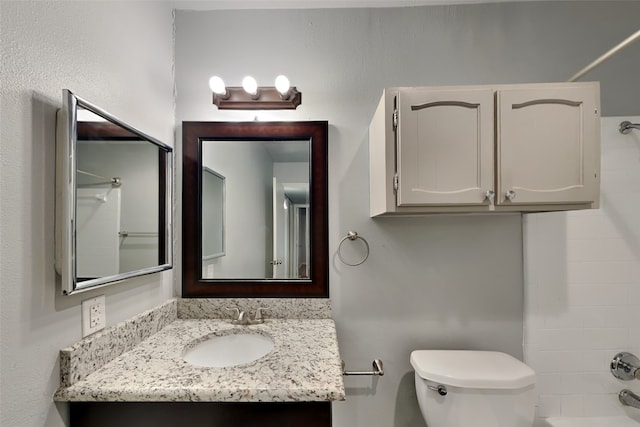 full bathroom featuring vanity, toilet, and bathing tub / shower combination