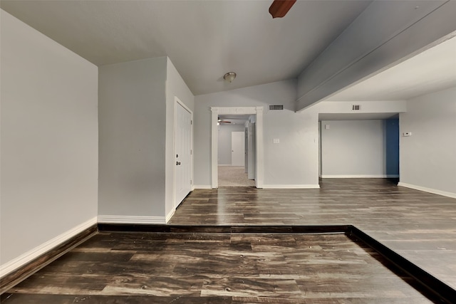 unfurnished room with ceiling fan, dark hardwood / wood-style flooring, and lofted ceiling