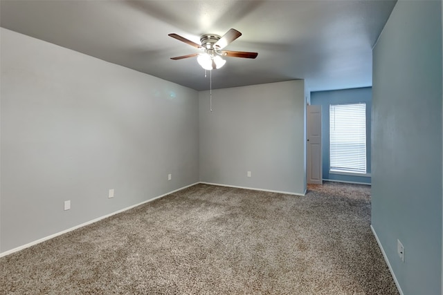 carpeted spare room with ceiling fan