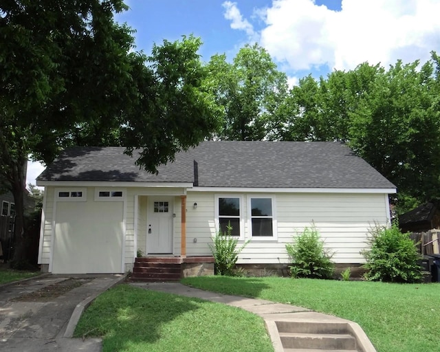 single story home featuring a garage and a front yard