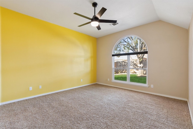 spare room with lofted ceiling, ceiling fan, and carpet